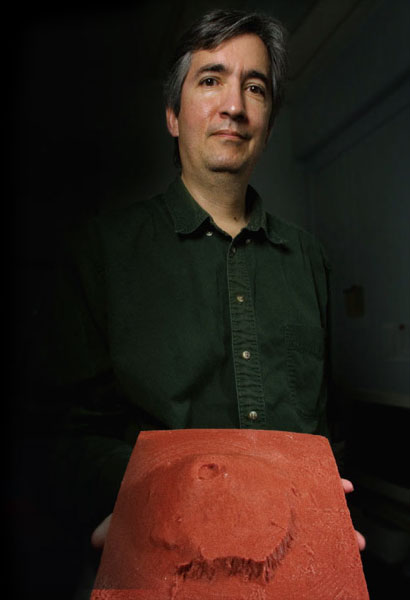 Goddard researcher John W. Keller and his 3-D model of Olympus Mons on Mars, the largest volcano in our solar system