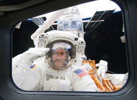 Astronaut Michael Good on Atlantis' remote manipulator system arm